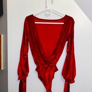 Red velveteen low-cut bodysuit with ribboned arms